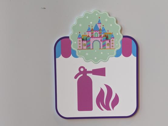 Sign in candy store with a picture of a fire extinguisher and a flame.