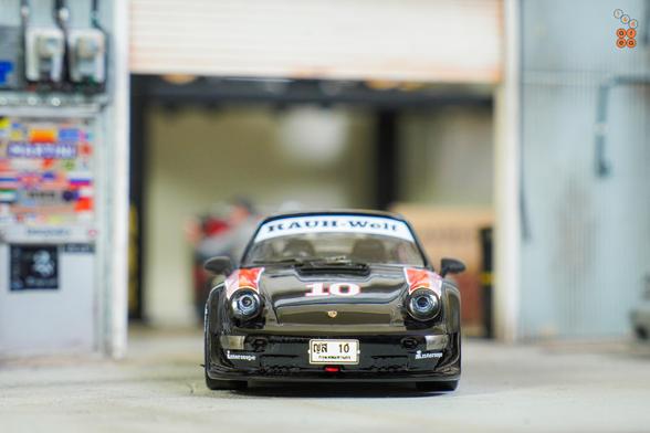 A front side of Porsche RWB 964 Black, No.10 Thailand Special Edition by Tarmac Works in 1:64 scale on AREA 164