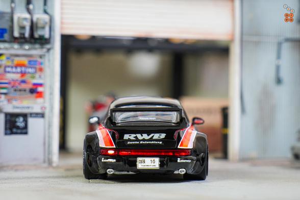 A rear side of Porsche RWB 964 Black, No.10 Thailand Special Edition by Tarmac Works in 1:64 scale on AREA 164