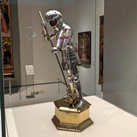 Statue in gold and silver of an armored knight slaying a dragon