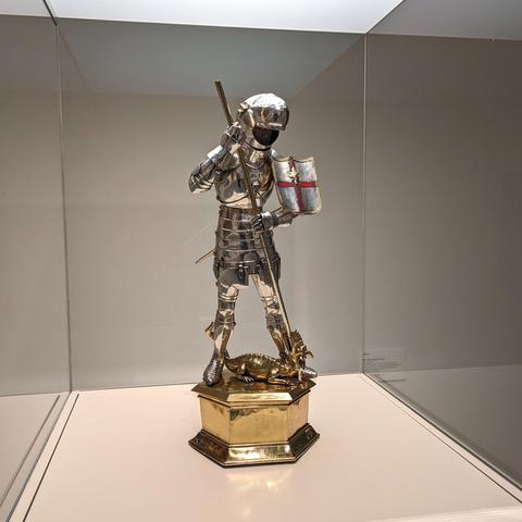 Statue in gold and silver of an armored knight slaying a dragon