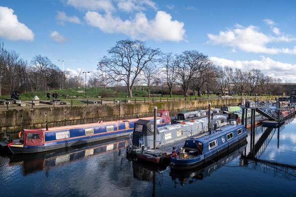 A photo titled "Nice Day in Three Mills Residential Moorings", taken near Fixed Weir, Three Mills Lock Weir by marc.barrot on Flickr.