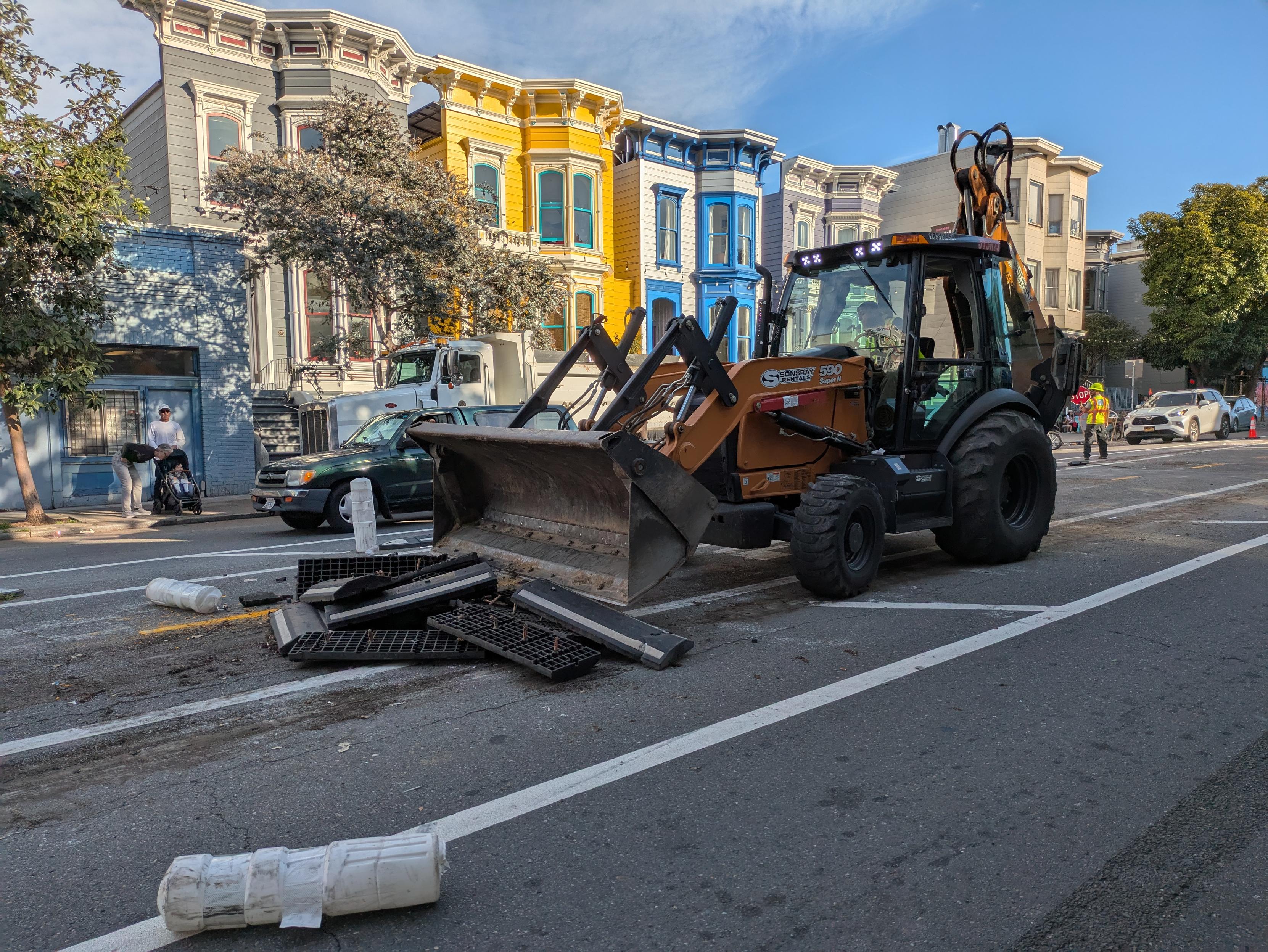 skip-loader removing rubber curbs