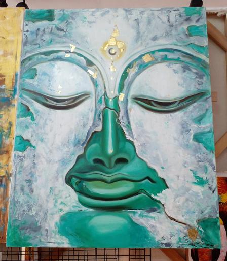 a painting of the buddha's face, it is a metallic aqua type of surface, a golden circle with a point to the north on his forehead, white patches of rocky mineral clouds passing over his face 