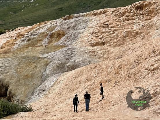 The Travertine Mineral Springs along Georgian Military Road (E-117 towards Verkhnii-Lars Russia border): https://thevagabondcouple.blogspot.com/2025/02/georgia-tbilisi-gudauri-kazbegi-russian-border-july-2021.html

Red & white terraced travertine mineral springs are formed through a fascinating geological process involving water, minerals & time when groundwater, heated by geothermal activity deep within the Earth, rises to the surface carrying dissolved calcium carbonate (CaCO₃) & other minerals. As the water emerges & cools, it releases carbon dioxide (CO₂) causing the calcium carbonate to solidify into travertine, a type of limestone. This process creates iconic white terraces often seen in these formations. The red or orange hues in some travertine terraces like this one, & rarely visited one a mile from white Pamukkale, Turkey terraces, come from the presence of iron oxide & other minerals also dissolved in the water. These minerals oxidize upon contact with air, giving the terraces their warm, reddish tones. Over time, the continuous flow of mineral-rich water builds up layers of travertine, forming the stepped, terraced structures that are both visually stunning and scientifically intriguing. The geological activity that drives these springs is linked to tectonic plate movements which create fractures in the Earth’s crust, allowing heated groundwater to rise.

#VagabondCouple #sakartvelo #Georgia #travertine #travel #travelblogger #traveltheworld #travelphotography