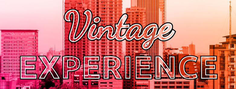Transparent text with a double stroke, black outer one and white inner one. Two different fonts are used, a cursive one on the top line and a sans-serif one on the bottom line.