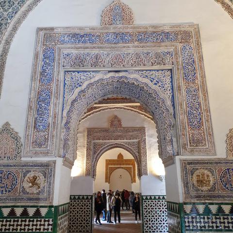A series of open archway, decorated in blue and gold, Islamic art and looking like something out of an elaborate fantasy series. But it's real. 