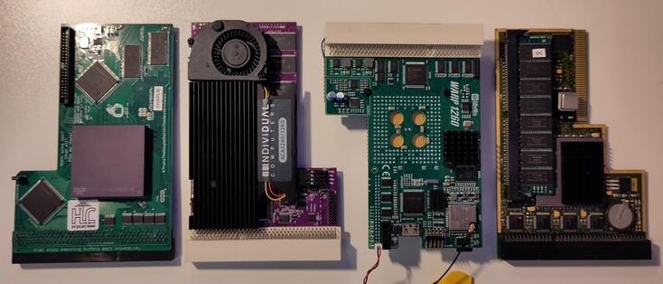 A series of 68060 accelerators for the Amiga 1200 laying on a white table laid out in a row.