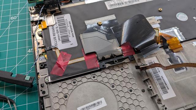 Fixing the trackpad connector with electric tape.