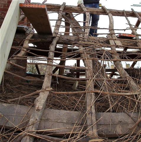 A roof devoid of any covering with the original timbers still in place.