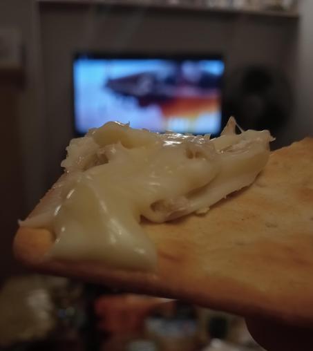 Gloopy cheese smeared on a Jacob's cracker with Star Trek (2009) on in the background... there is also a hidden glass of chilled Sauvignon Blanc 