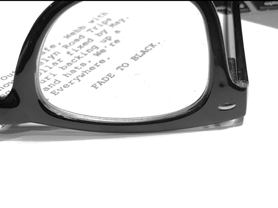 A pair of glasses on a piece of paper that says fade to black