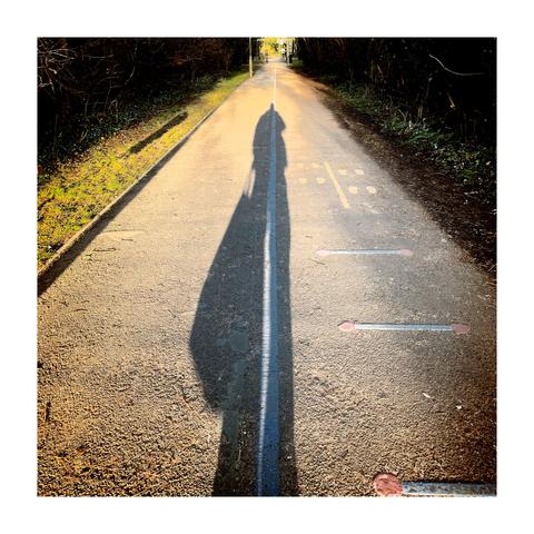 Self portrait of my own long shadow cast by low winter light