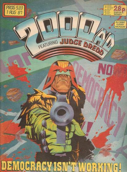 The front cover of 2000AD Prog 533 for 1 August 1987, featuring cover art by John Higgins showing Judge Dredd pointing a gun at the viewer against a backdrop of banners and placards above the slogan "Democracy isn't working!" in a scene from the iconic three-part story Revolution.