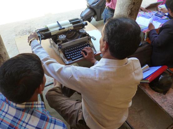 Photograph of a street typist in India by David Brewer of Media Helping Media, released via Creative Commons