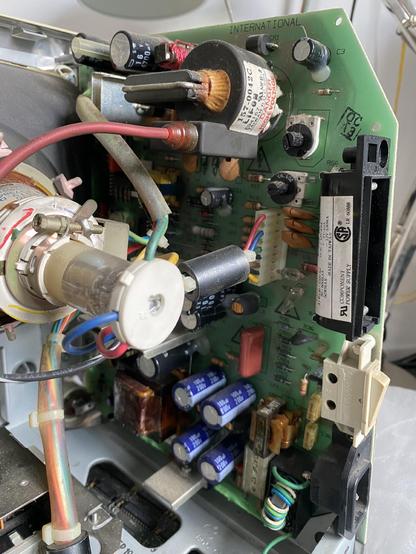 Picture of the analog board of a Mac Plus. The CRT neck can be seen to the left.
