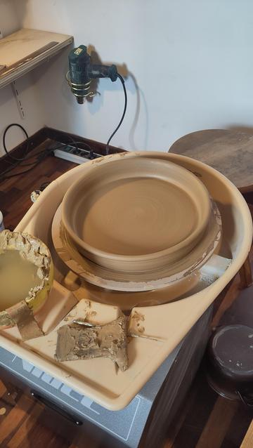 Una cassola baixa acaba de de fer sobre la roda d'un torn terrissaire. Falta pol·lir i posar les nanses.