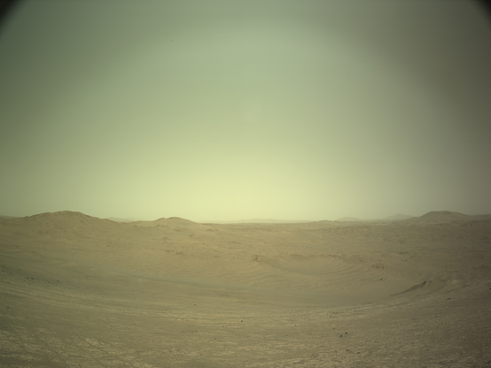 An ochre toned image capturing a Martian landscape of hills and dunes.