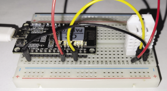 Photo of a low cost Arduino NodeMCU module is connected to a DHT22 sensor
