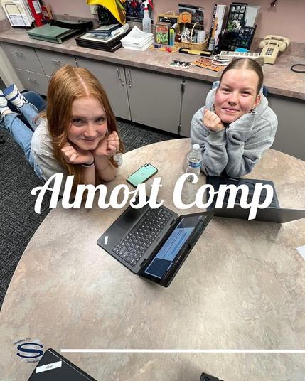 A photo of students with a laptop