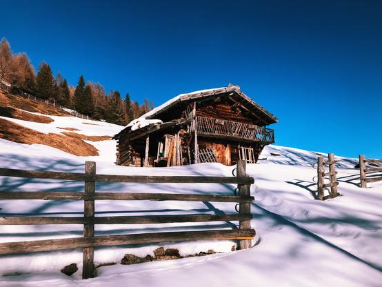A lonely mountain hut surrounded by snow