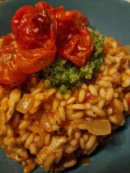 Delicious risotto with homemade broth, onions, white wine, butter, parmezan, etc. Tomatoes in it (pelati) and roasted roma tomatoes in the oven and a dollop of pesto ib top. O so tasty