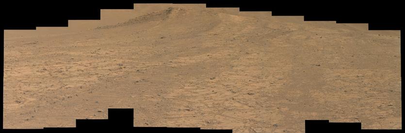 An ochre toned mosaic capturing a Martian landscape of outcrops, a hill, and distant dunes in the background.