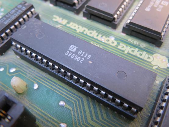 Photograph of the 6502 microprocessor inside an Apple II plus.