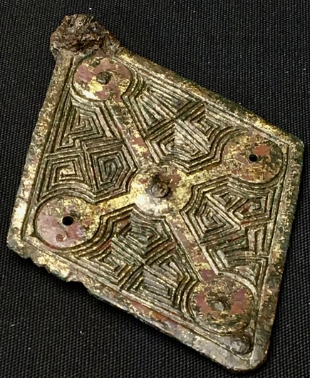 An incised Anglo-Saxon brooch from the Staffordshire Hoard. 