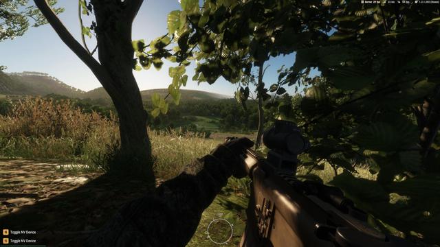 A screenshot from Arma Reforger.

I'm laying in a bush, overlooking a picturesque valley, with the sun rising over the hills behind. It's all quite magical, with fields centre of frame, and woods on either side.

There's a small tree just in front of me to the left, and to the right is the bush I'm in, silhouetted