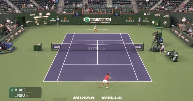 Magda Linette (far court) and Jessica Pegula (near court) play the 1st point
	
