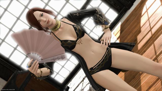 Esi poses for the camera in her new Summer  Sunset attire. Left hand on her hip while the right one holds a pink fan next to her face.