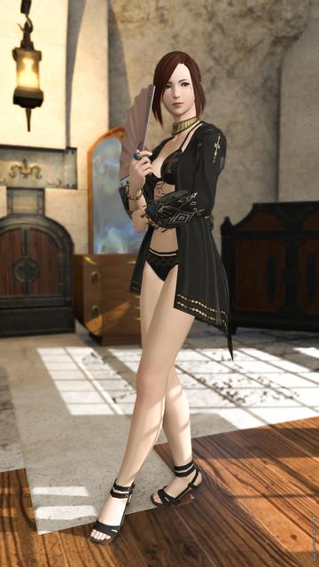 Esi standing with arms crossed, one hand holding a fan close to her face, one leg in front of the other.