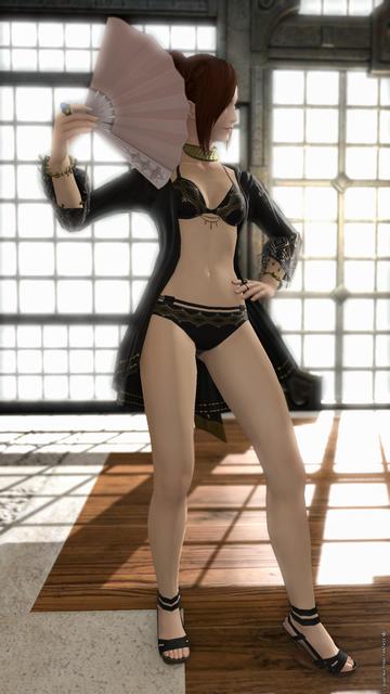 Full body shot of Esi posing in her beach outfit, light coming through the window in the background.