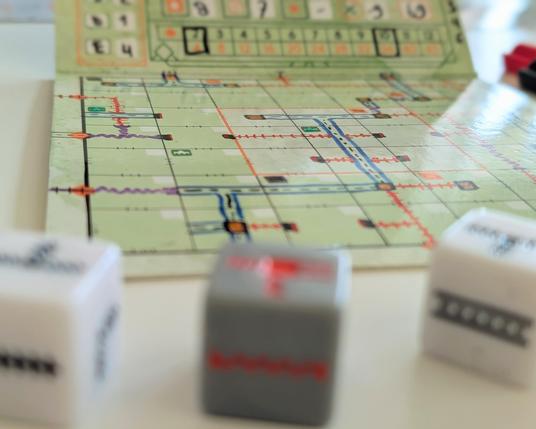 Close up of board game, blurry dice in front.