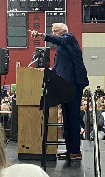 Bernie Sanders at podium pointing at someone in the audience 