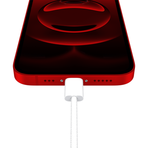 Apple's cheaper iPhone 16e, now with Product Red. A shot upwards from the USB-C port with the knitted cable attached.