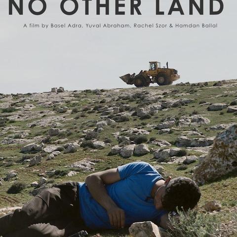 poster of No Other Land, showing director Basel Adra lying on rocks, turning his back to a bulldozer in the distance