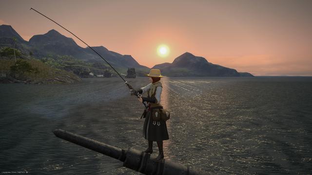 Esi stands on the boom of the fishing boat with her rod out to the ocean, waiting for a fish to take the bait. Behind, the sun sets behind the mountains out in the distance.