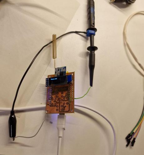 Pager prototype connected to the oscilloscope probe with two wires