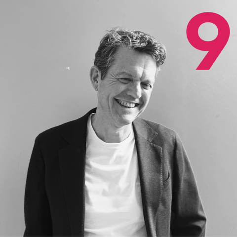 Black and white photo of Simon Forster, General Manager of Quad9, with the signature magenta 9 from the Quad9 logo in the top right corner.