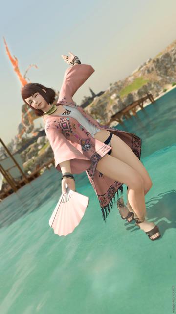 Esi dances around in the shallow water, wearing her new beach/fishing outfit.