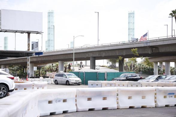 Vehicles entering and exiting the rideshare area at the LAX airport that is protected by TrafFix Water-Wall barriers.