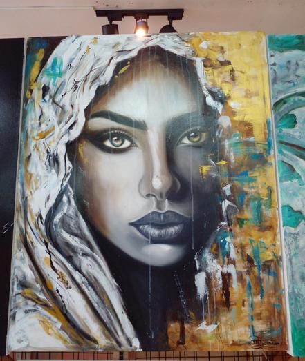 a painting of a woman with a white veil over her head, vegetative and earth tones around her, one of her eyes is light green, the other amber colored , she is looking at the viewer seen from the bottom of her neck up 
