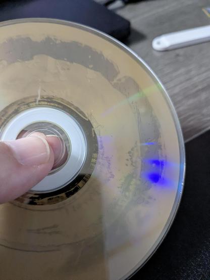 A photo of a terribly de-laminated DVD.