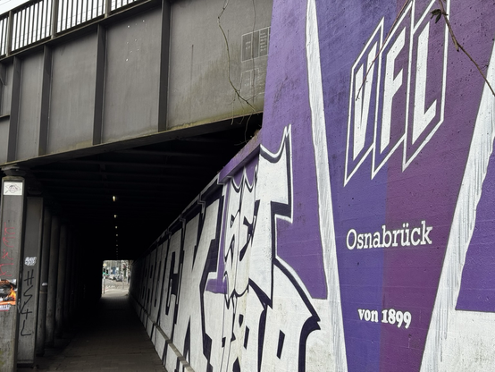 Durchgang unter der Bremer Brücke. An denn Wänden Logo und Signet des VfL Osnabrück.