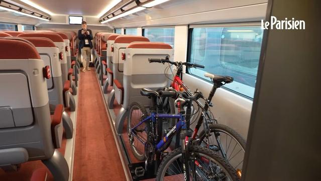 Video screenshot of a first-class area with 2 bicycles behind the column of single seats at the carriage entrance. Source: https://youtube.com/watch?v=EDqIPfuGF8U at 24 seconds.
