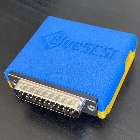 3/4 view of a BlueSCSI. The 3D printed shell is blue and yellow, in the colors of the Ukrainian flag.