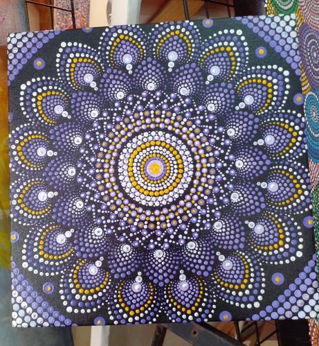 a purple and white and yellow floral mandala on black 