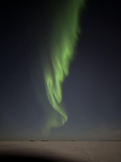 Some very loopy curves of aurora over a moonlit bit of sea ice 
